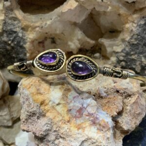 Amethyst bracelet displayed on rocks