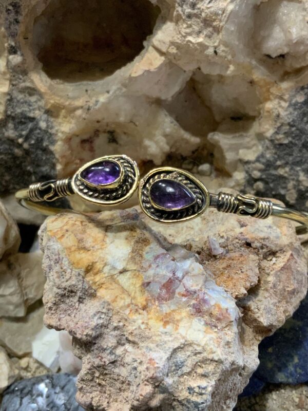 Amethyst bracelet displayed on rocks