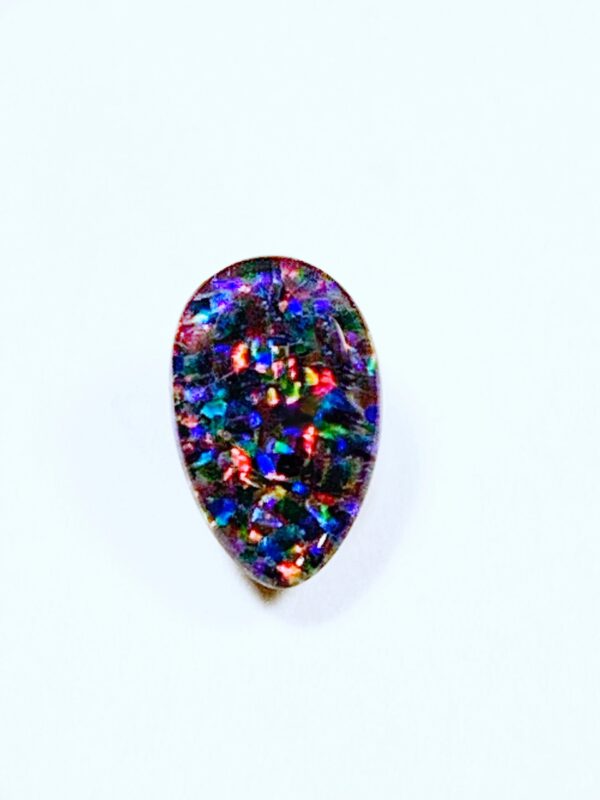 Colorful teardrop gemstone on white background