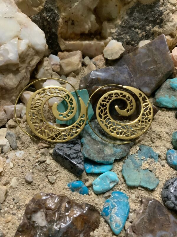 Intricate earrings among colorful stones