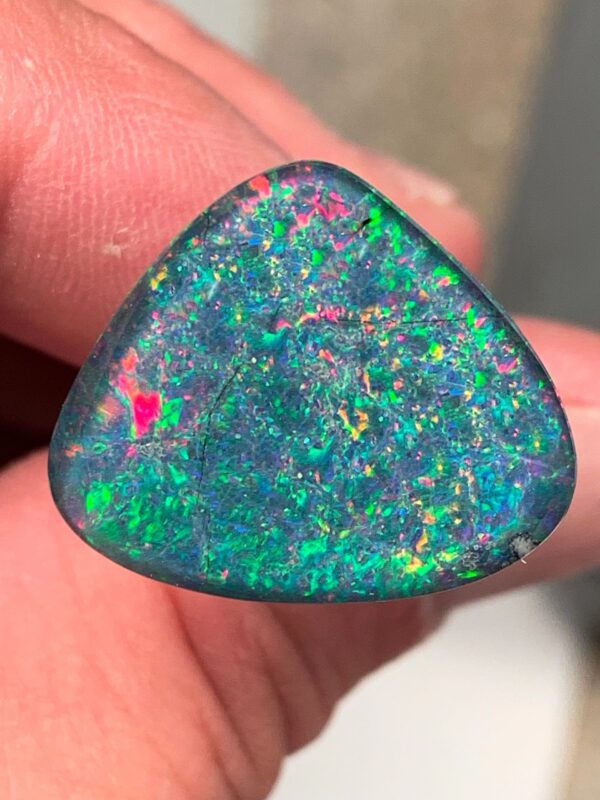 Triangular opal displaying iridescent hues