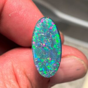 Colorful opal gemstone held by hand