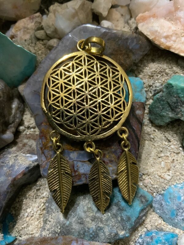 Intricate metal design with dangling feathers