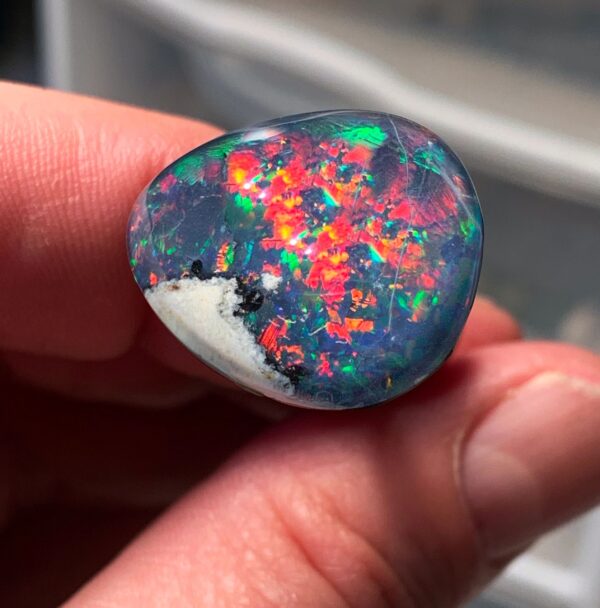 Colorful opal gemstone in hand