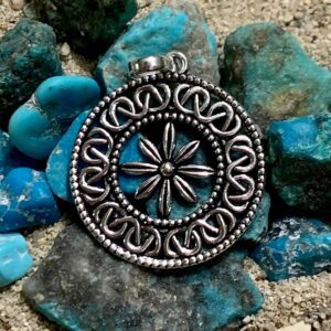Silver pendant on turquoise stones