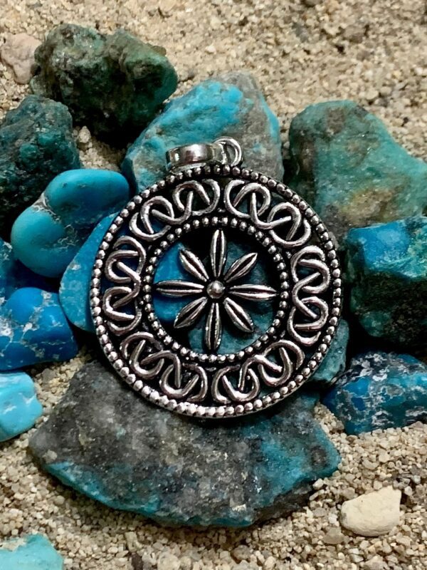 Silver pendant on turquoise stones