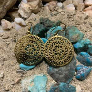 Filigree earrings on rocky surface