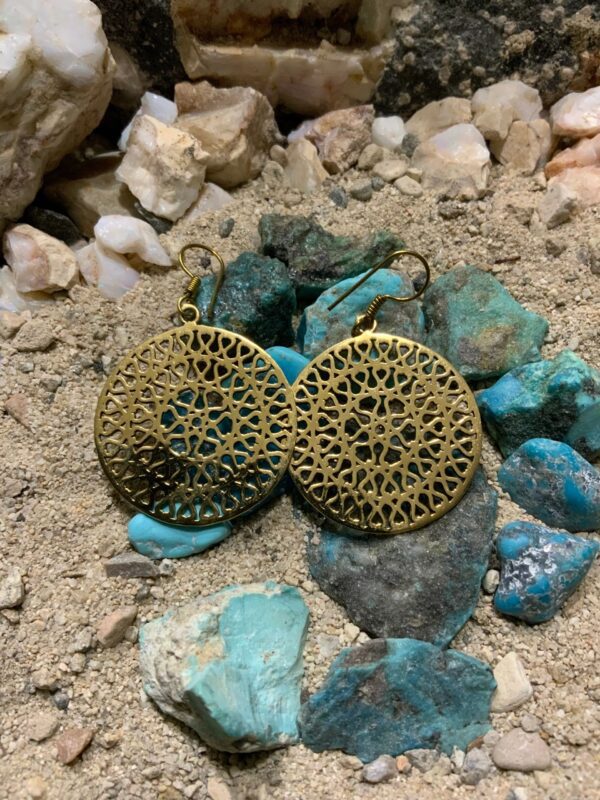 Filigree earrings on rocky surface