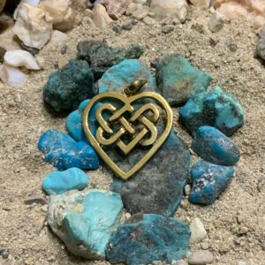 Gold heart pendant on turquoise stones