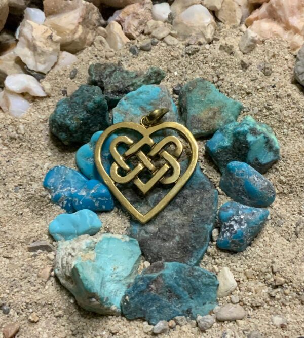 Gold heart pendant on turquoise stones