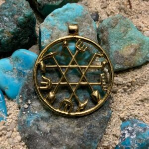 Intricate pendant with Hebrew letters on rocks