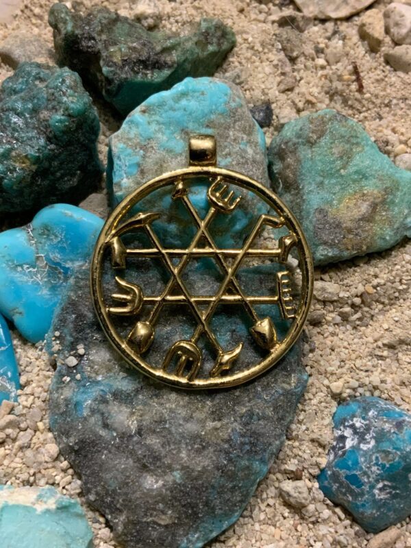 Intricate pendant with Hebrew letters on rocks