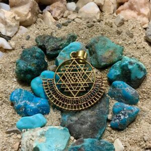 Geometric jewelry on sandy ground