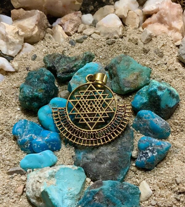 Geometric jewelry on sandy ground