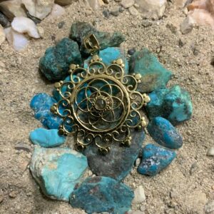 Gold pendant on turquoise stones