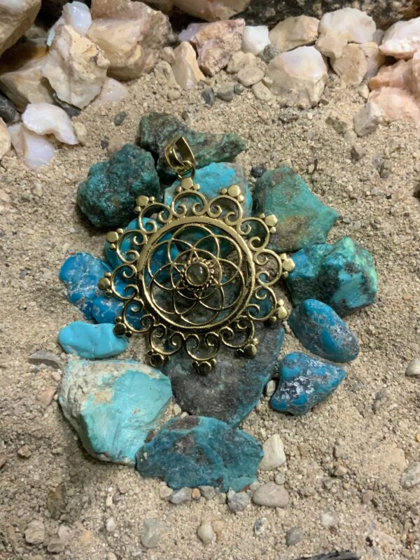 Gold pendant on turquoise stones