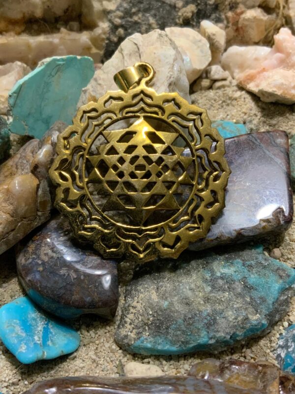 Geometric pendant resting on minerals