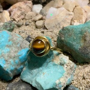 Tiger's eye ring on turquoise stones