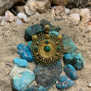 Ornate necklace on rocky surface