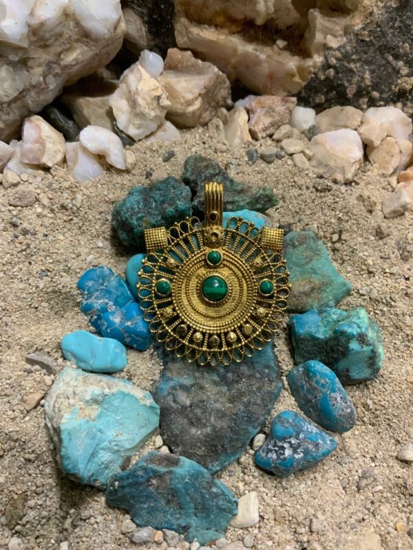 Ornate necklace on rocky surface