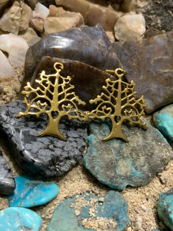 Golden earrings with intricate tree design