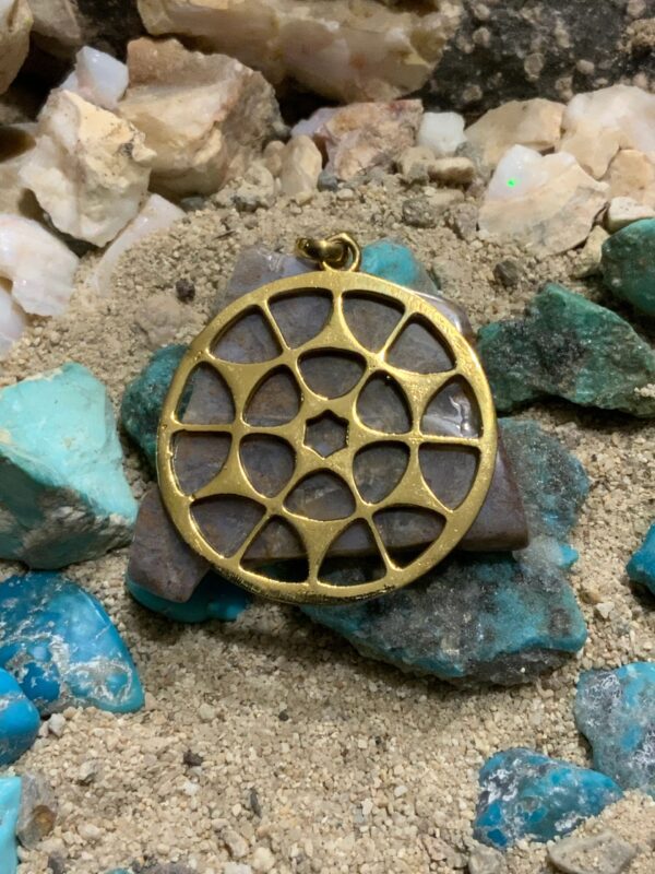 Golden pendant on turquoise stones