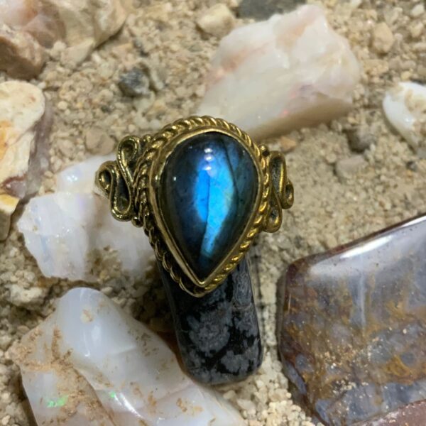 Blue gemstone ring on sandy surface