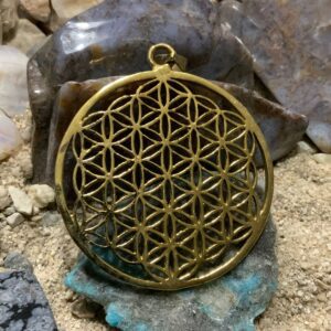 Ornate circular charm on stones