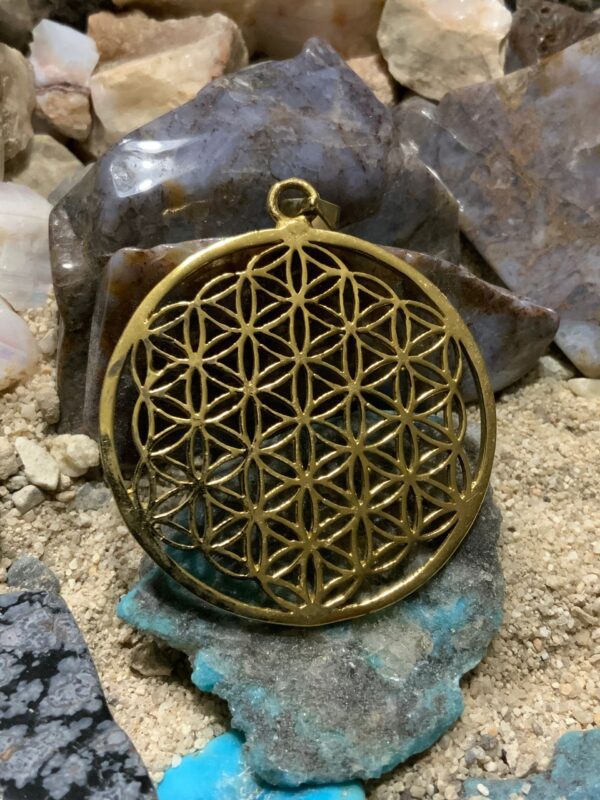 Ornate circular charm on stones