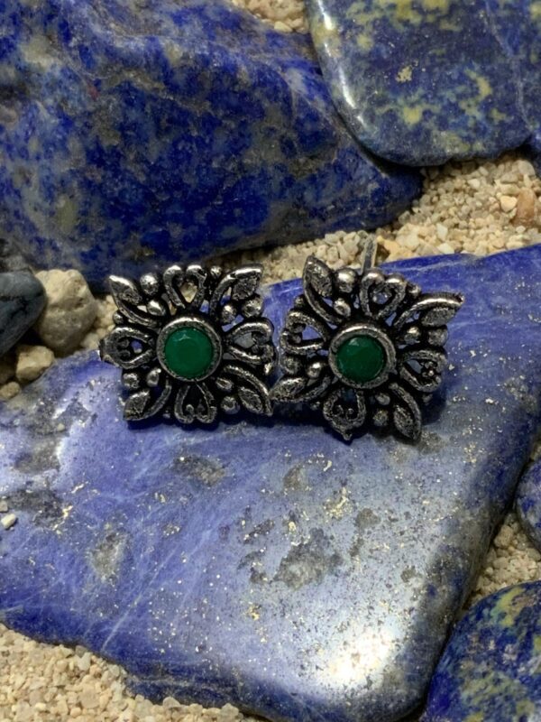 Ornate earrings with green center stones