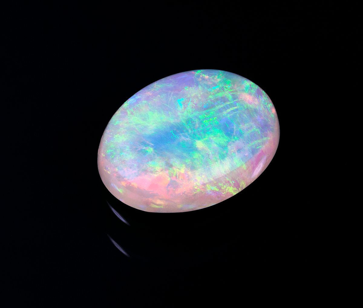 Luminous opal gemstone on black background