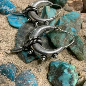 Silver hoop earrings on turquoise stones