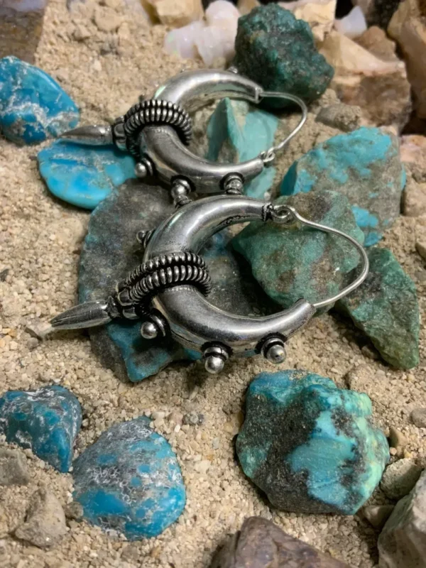 Silver hoop earrings on turquoise stones