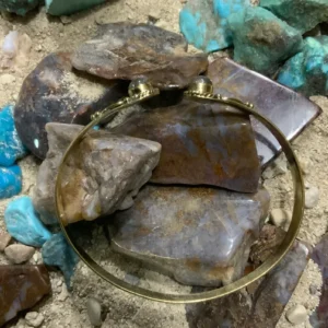 Golden bracelet on colorful stones