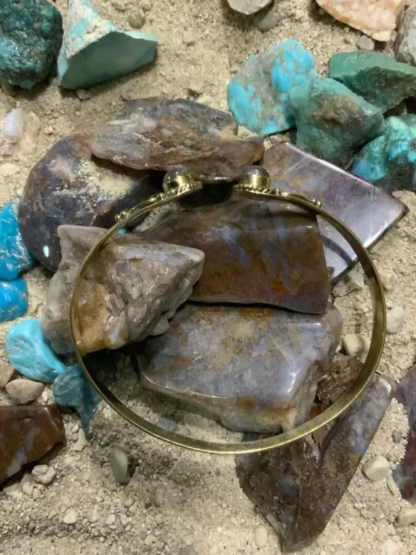 Golden bracelet on colorful stones