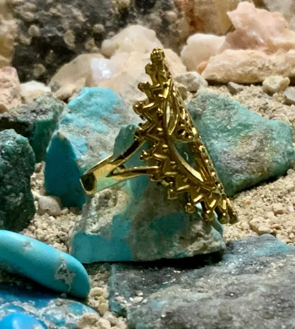 Intricate ring atop blue rocks