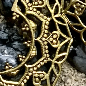 Elaborate gold accessory on dark stones