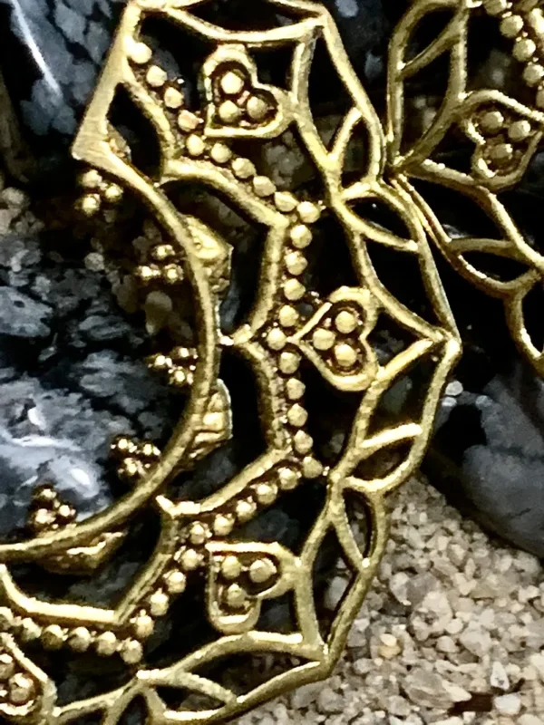 Elaborate gold accessory on dark stones