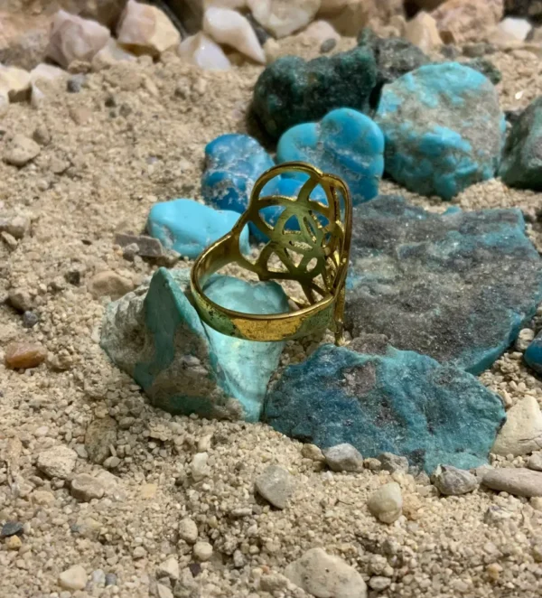 Jewelry resting on sand with stones